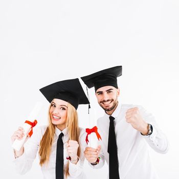 cheerful young graduating couple. High resolution photo