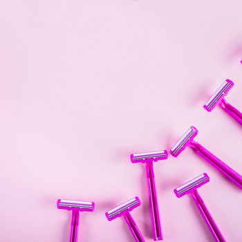 high angle view razors pink backdrop. High resolution photo