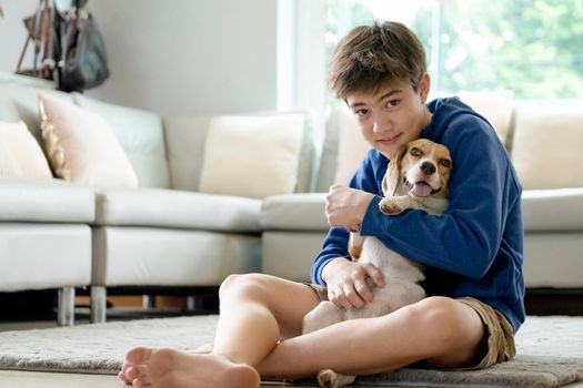 Child Playing With His Pet Dog At Home.
