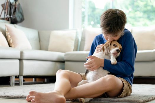 Child Playing With His Pet Dog At Home.
