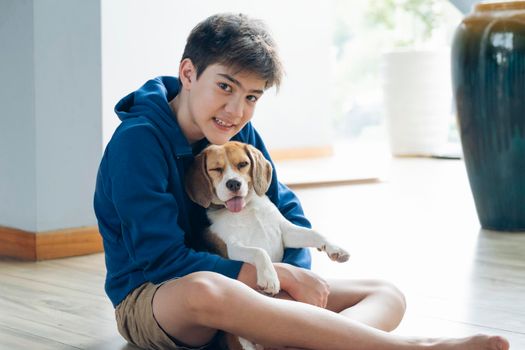 Child Playing With His Pet Dog At Home.
