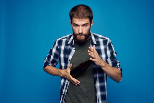 a man in a plaid shirt drinking beer alcohol emotion isolated background. High quality photo