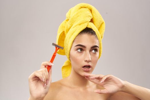 cheerful woman razor in hand skin care hygiene. High quality photo