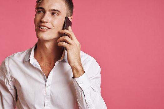 portrait of a man with a phone in hand fashion posing studio lifestyle. High quality photo