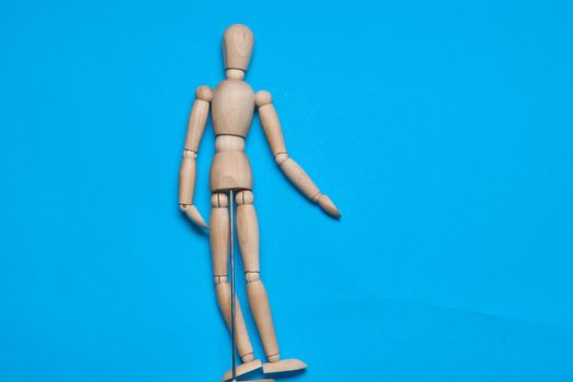 wooden man mannequin blue background design object. High quality photo
