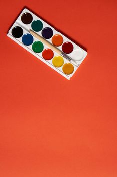 watercolor paint on red background drawing art supplies for artist. High quality photo