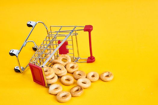 carts with groceries shopping supermarket store yellow background. High quality photo