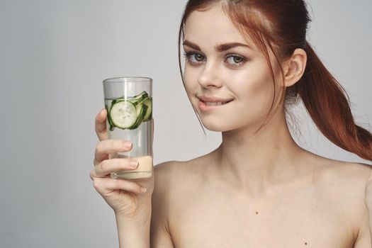 woman with cucumber drink health vitamins close-up. High quality photo