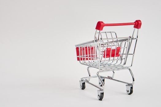 empty trolley on light background shopping supermarket service. High quality photo