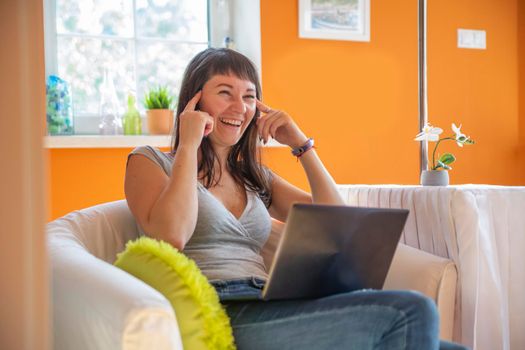 beautiful young woman emotionally looking at laptop. Emotionally surprised and cry for success.