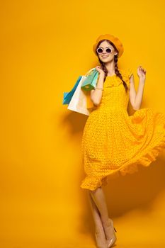pretty woman shopping entertainment lifestyle yellow background. High quality photo