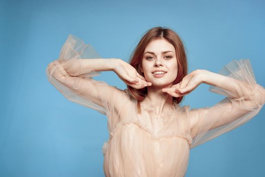 portrait of a woman in beige dress posing charm model studio. High quality photo