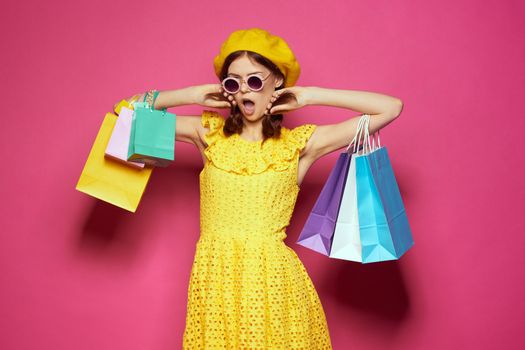 pretty woman yellow dress shopping fun isolated background. High quality photo