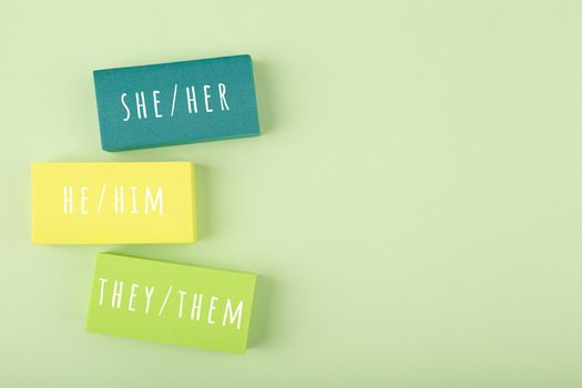 Correct pronouns for different genders on light green background with copy space. Concept of Lgbtq plus, transgender and bigender tolerance, respect and equal rights