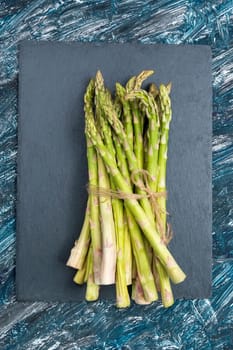 Fresh Asparagus, on old dark rustic background. Top view. Vertical video