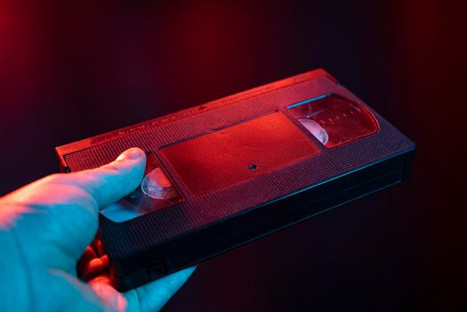 VHS cassette detail taken in hand in a dark lights
