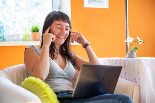 beautiful young woman emotionally looking at laptop. Emotionally surprised and cry for success.