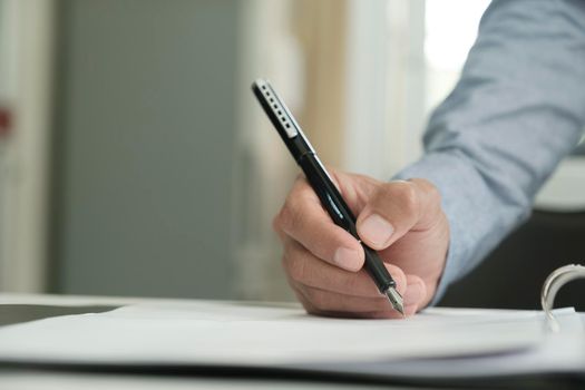 Close Up Of Businessman Signing A Contract.