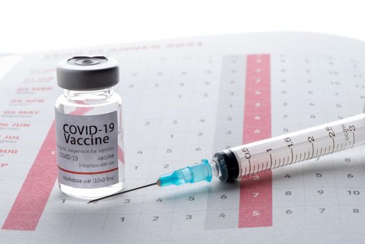 In the calendar, syringe with container of epidemic vaccine.