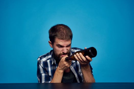 a man in a plaid shirt drinking beer alcohol emotion isolated background. High quality photo