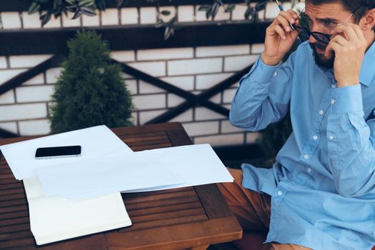 bearded man work documents technology manager in cafe. High quality photo