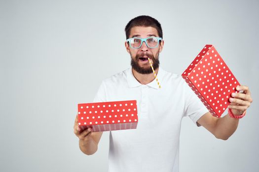 Cheerful man with gift in glasses holiday lifestyle fashion surprise. High quality photo