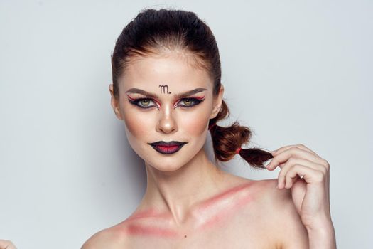 attractive woman naked shoulders cosmetics bright makeup color background. High quality photo