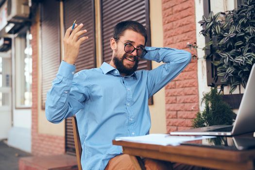 manager working in cafe with laptop outdoors. High quality photo