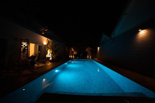 illuminated pool in the dark at night