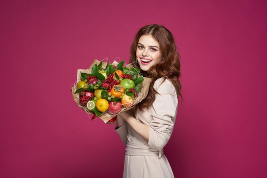 cheerful woman fun posing fruit bouquet vitamins isolated background. High quality photo