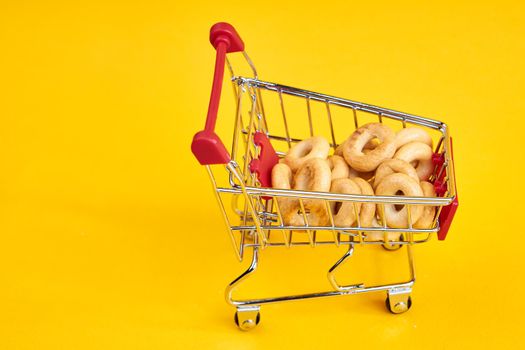 carts with groceries shopping supermarket store yellow background. High quality photo