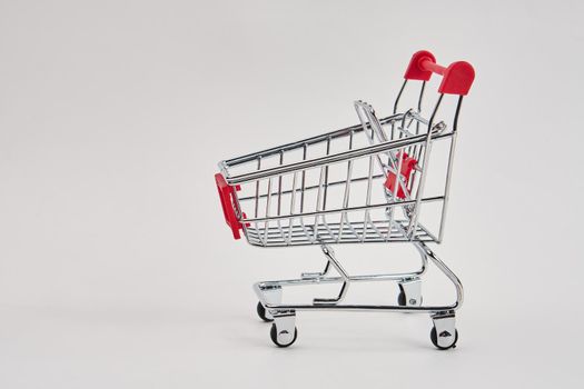 empty trolley on light background shopping supermarket service. High quality photo