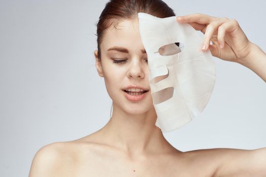 woman with bare shoulders and face mask skin care cosmetics. High quality photo