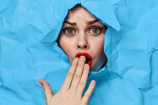 female face blue background red lips makeup emotions. High quality photo