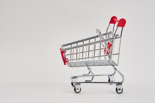 empty trolley on light background shopping supermarket service. High quality photo