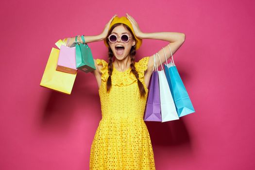 pretty woman yellow dress shopping fun isolated background. High quality photo