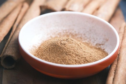 Cinnamon sticks and cinnamon powder on white background