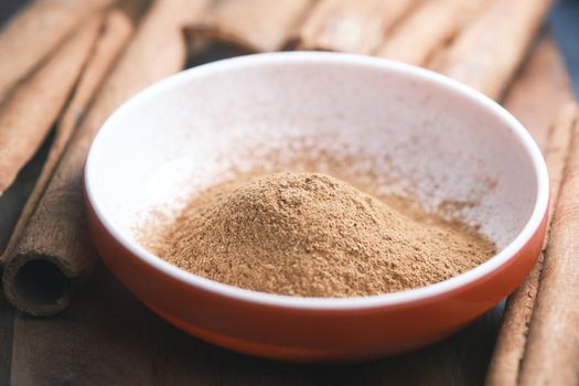 Cinnamon sticks and cinnamon powder on white background