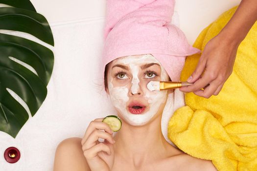 pretty woman face mask skin cleansing palm leaf view from above. High quality photo