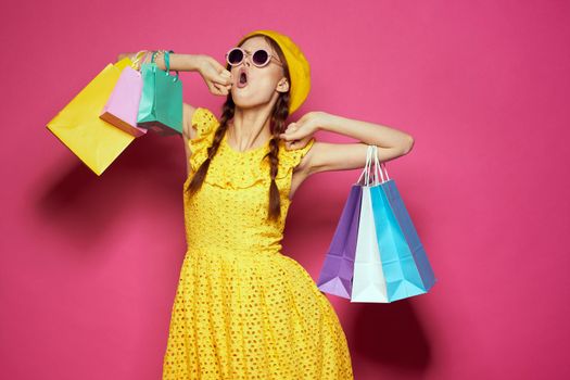 pretty woman yellow dress shopping fun isolated background. High quality photo