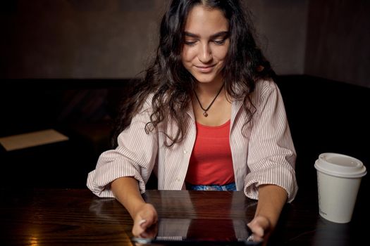 woman in restaurant sits by the table morning rest breakfast device. High quality photo