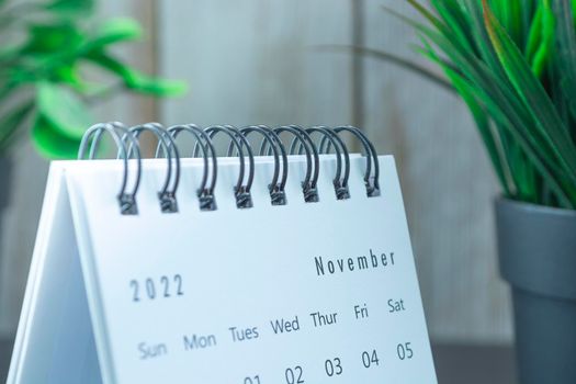 Blurred white September 2022 calendar with potted plant. 2022 New Year Concept