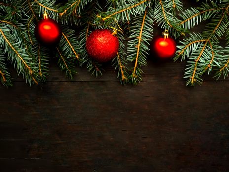 Christmas background with fir tree and three red balls.Decor for new year.