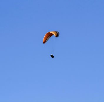 People paragliding in Santa Pola on a sunny day of Autumn