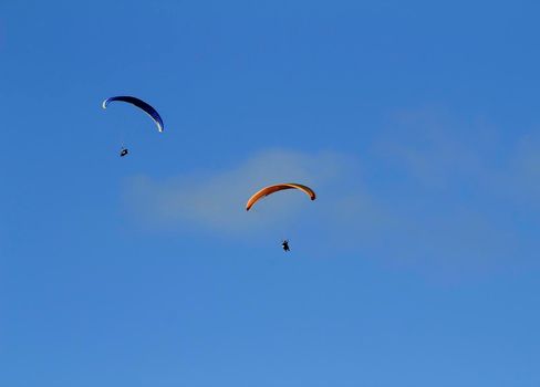 People paragliding in Santa Pola on a sunny day of Autumn