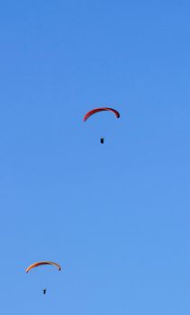 People paragliding in Santa Pola on a sunny day of Autumn