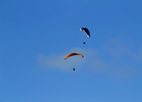 People paragliding in Santa Pola on a sunny day of Autumn