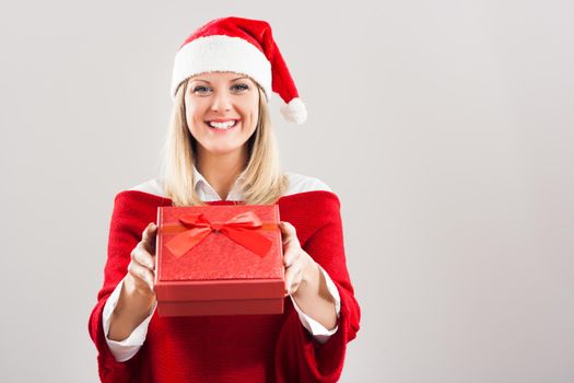 Beautiful woman with Santa hat holding gift.