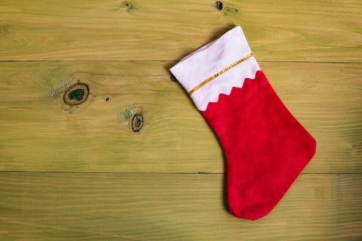 Image of Christmas Stocking on wooden table.