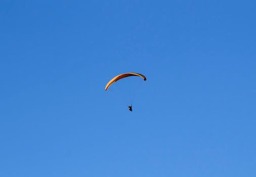People paragliding in Santa Pola on a sunny day of Autumn